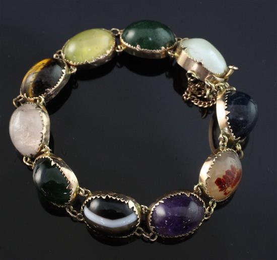 An Edwardian 9ct gold and multi cabochon gem set bracelet, approx. 6in.